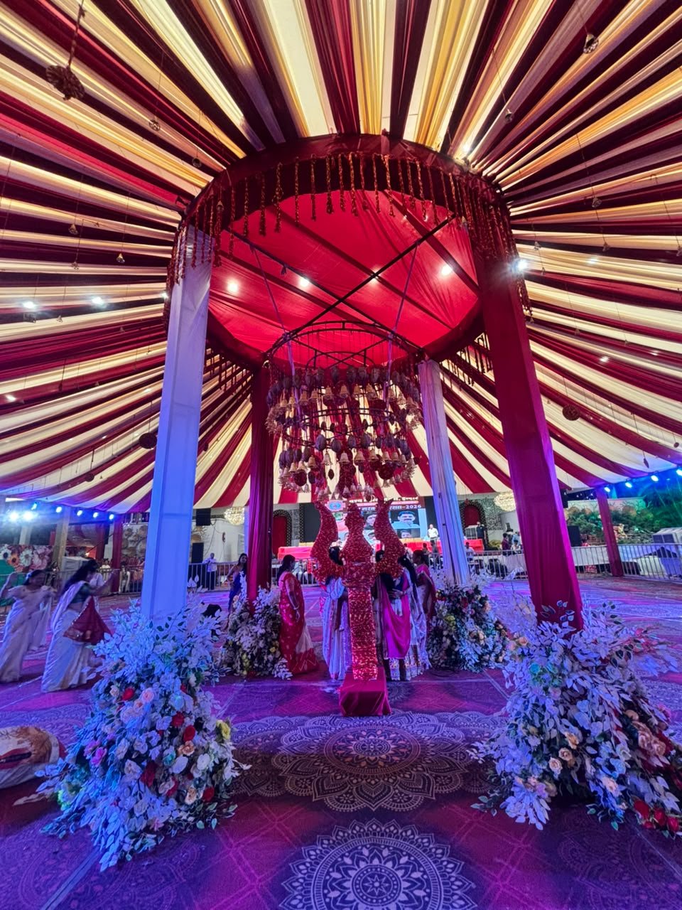 A striped tent and a red jhoomar